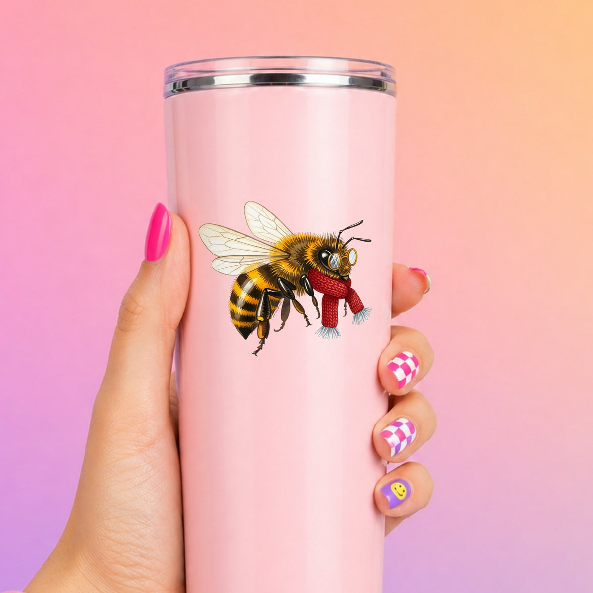 Bee With Spectacles And Red Scarf UV DTF sticker applied to a tall pink tumbler on a pink and orange background