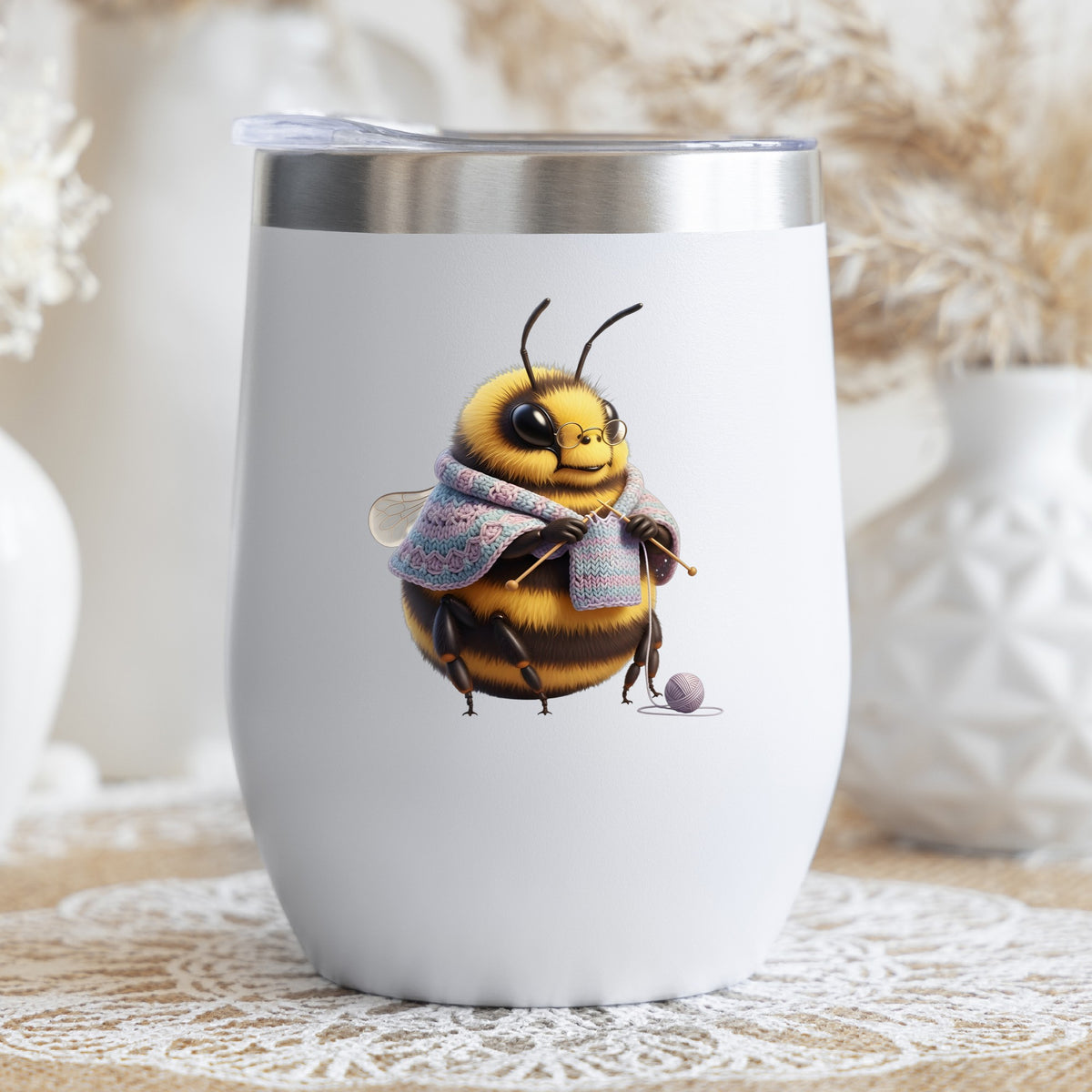 Bee Knitting In Shawl UV DTF sticker applied to a white stemless tumbler with a lid