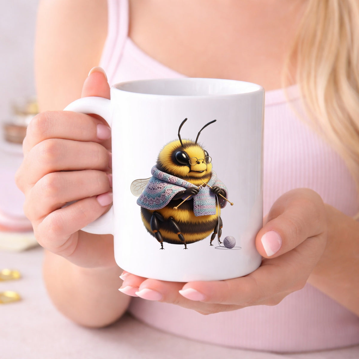 Bee Knitting In Shawl UV DTF sticker applied to a white coffee mug held in both hands