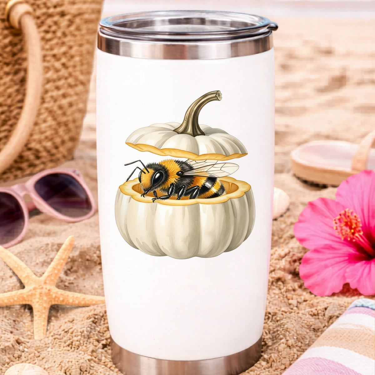 Sleepy Bee Inside White Pumpkin UV DTF sticker applied to a white travel tumbler on beach sand