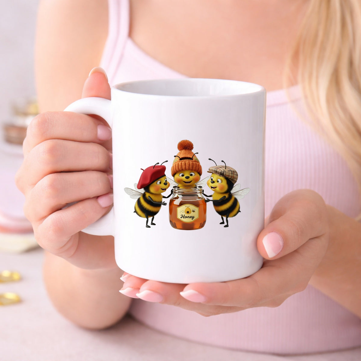 Three Bees With Honey Jar UV DTF sticker applied to a white coffee mug held in both hands