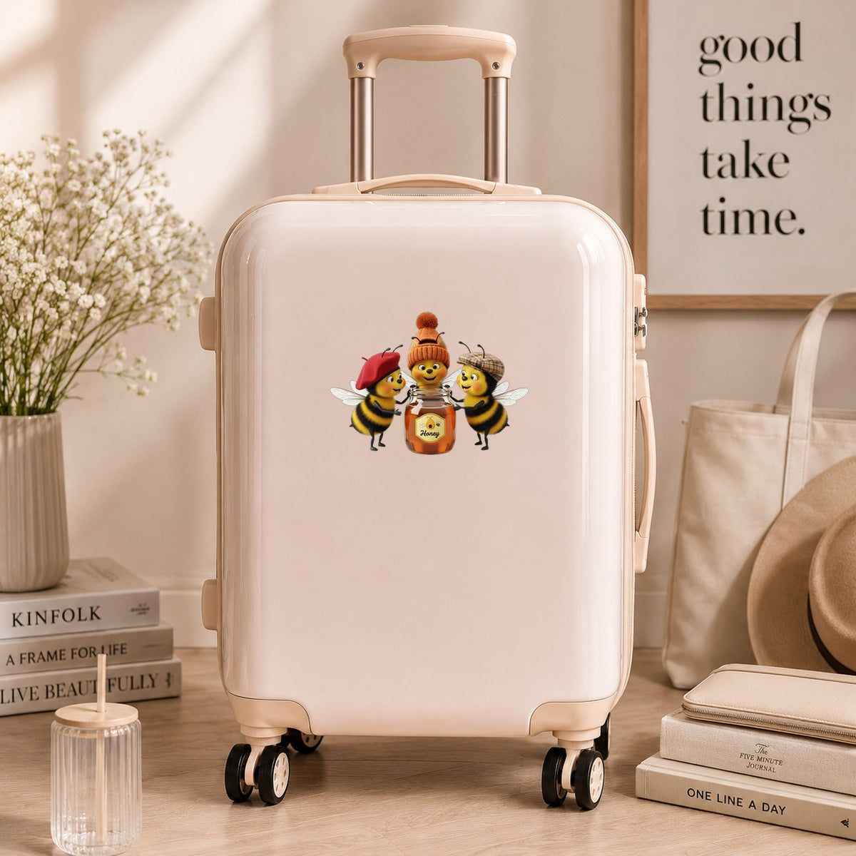 Three Bees With Honey Jar UV DTF sticker applied to a cream carry-on suitcase