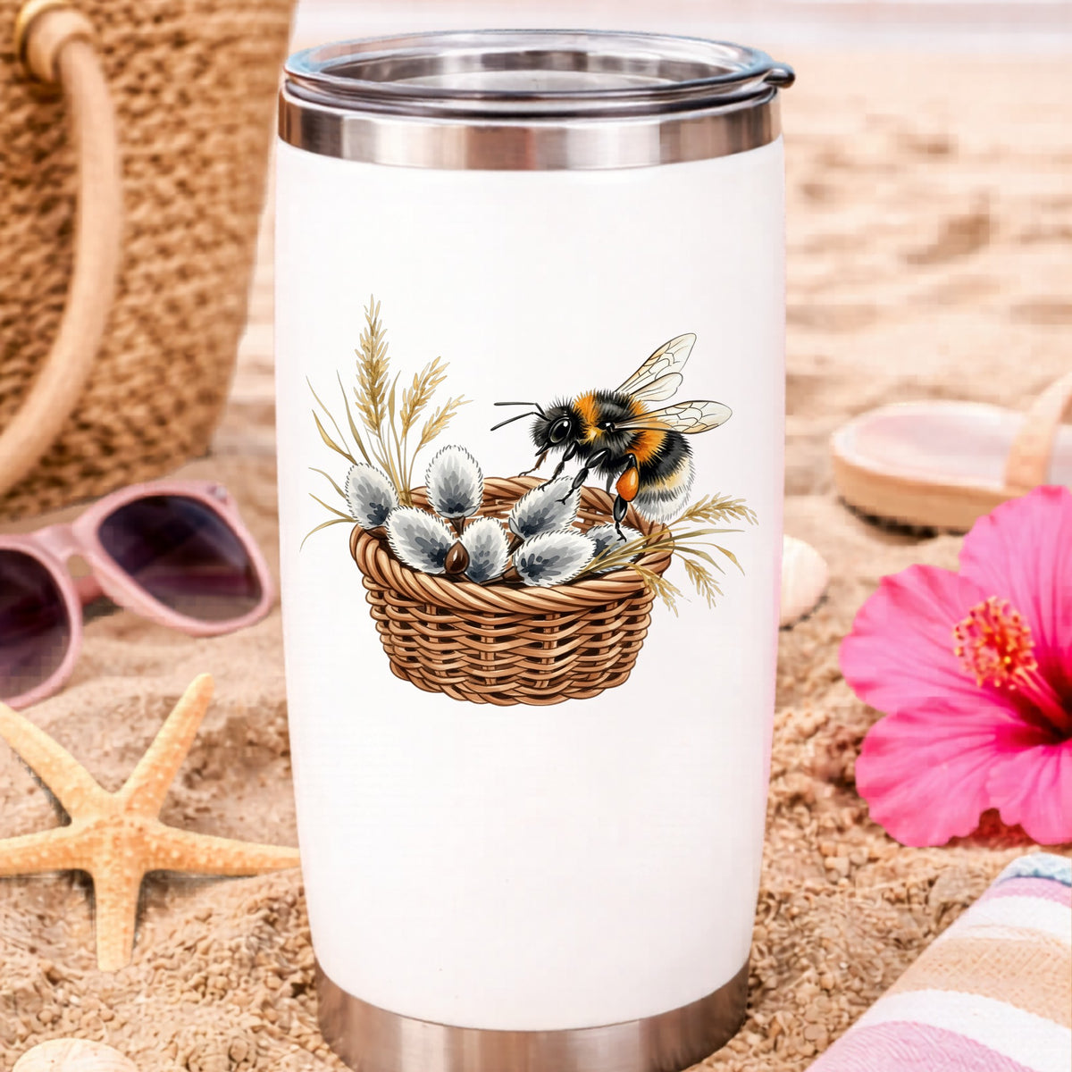 Bumble Bee On Basket Of Pussy Willow UV DTF sticker applied to a white travel tumbler on beach sand