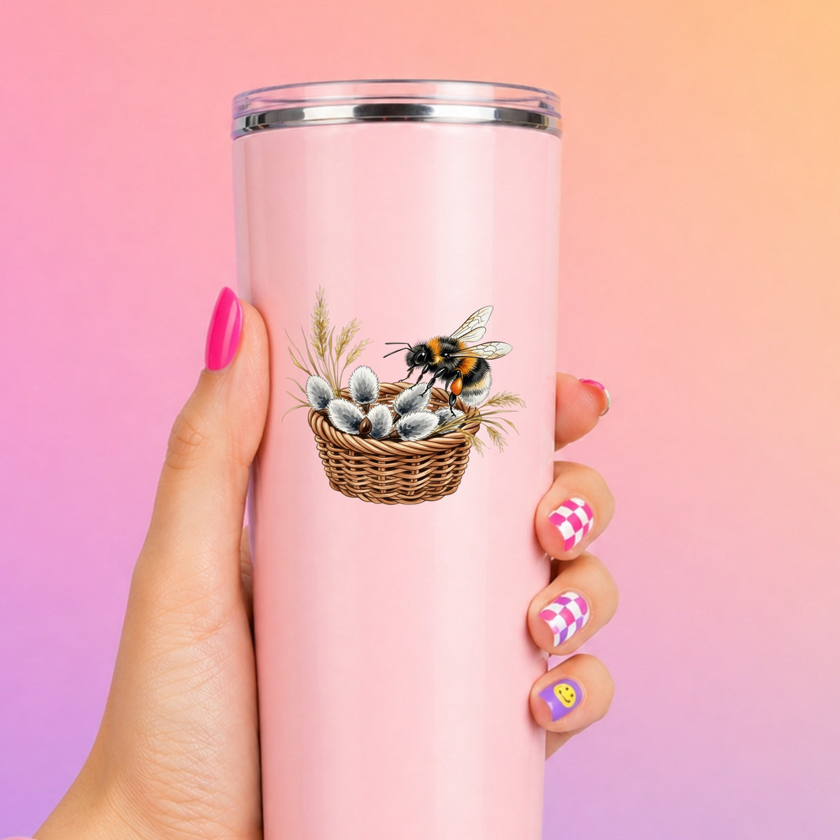 Bumble Bee On Basket Of Pussy Willow UV DTF sticker applied to a tall pink tumbler on a pink and orange background