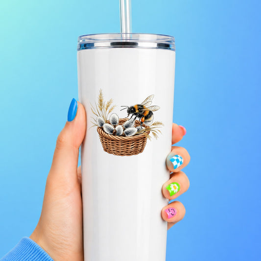 Bumble Bee On Basket Of Pussy Willow UV DTF sticker applied to a white straw tumbler on a blue background
