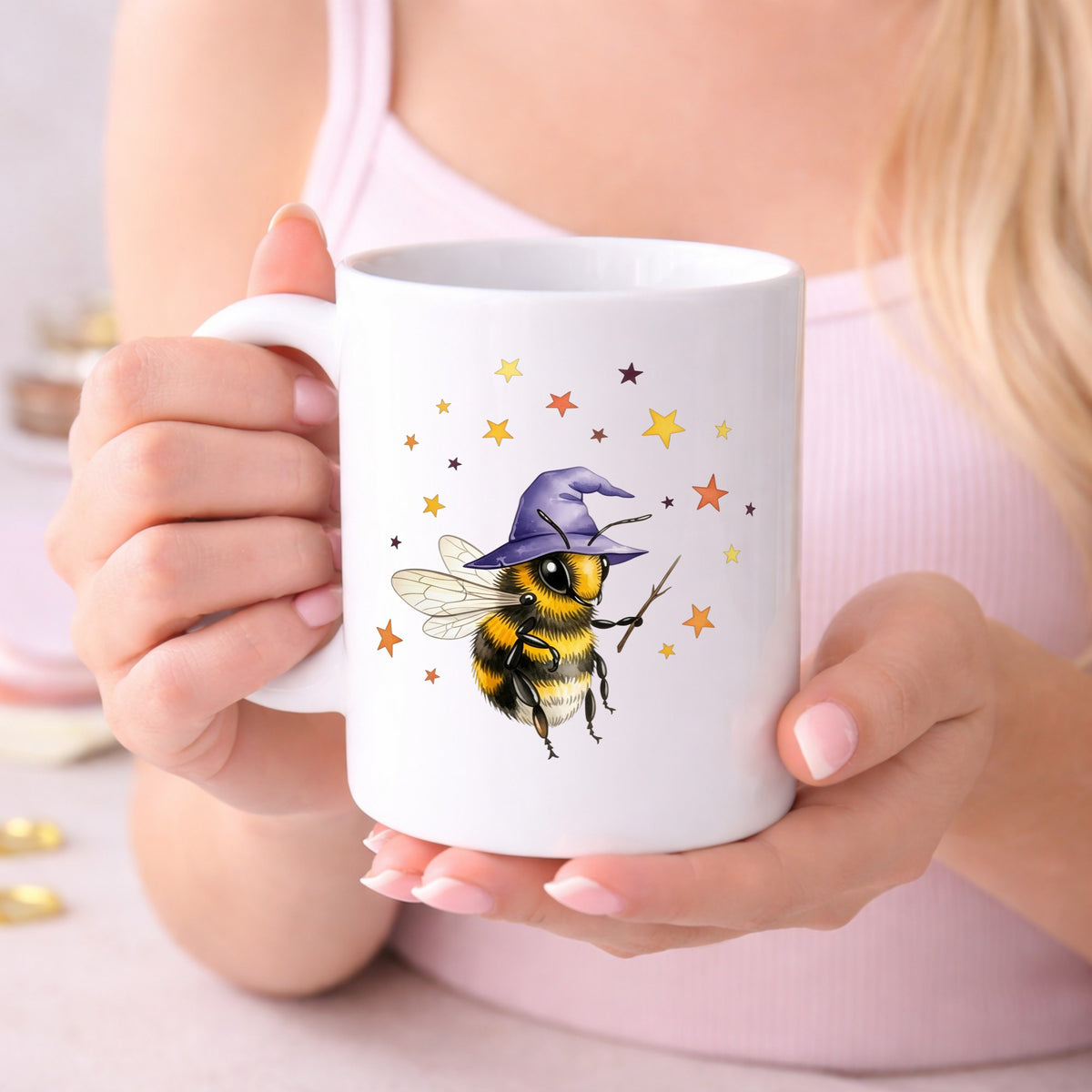 Bee Wizard With Stars UV DTF sticker applied to a white coffee mug held in both hands