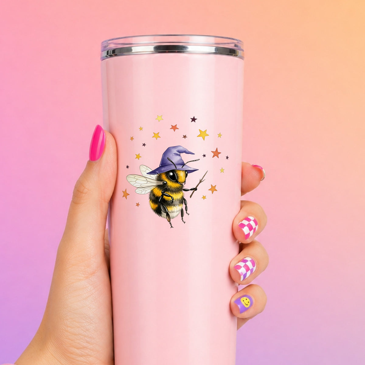 Bee Wizard With Stars UV DTF sticker applied to a tall pink tumbler on a pink and orange background
