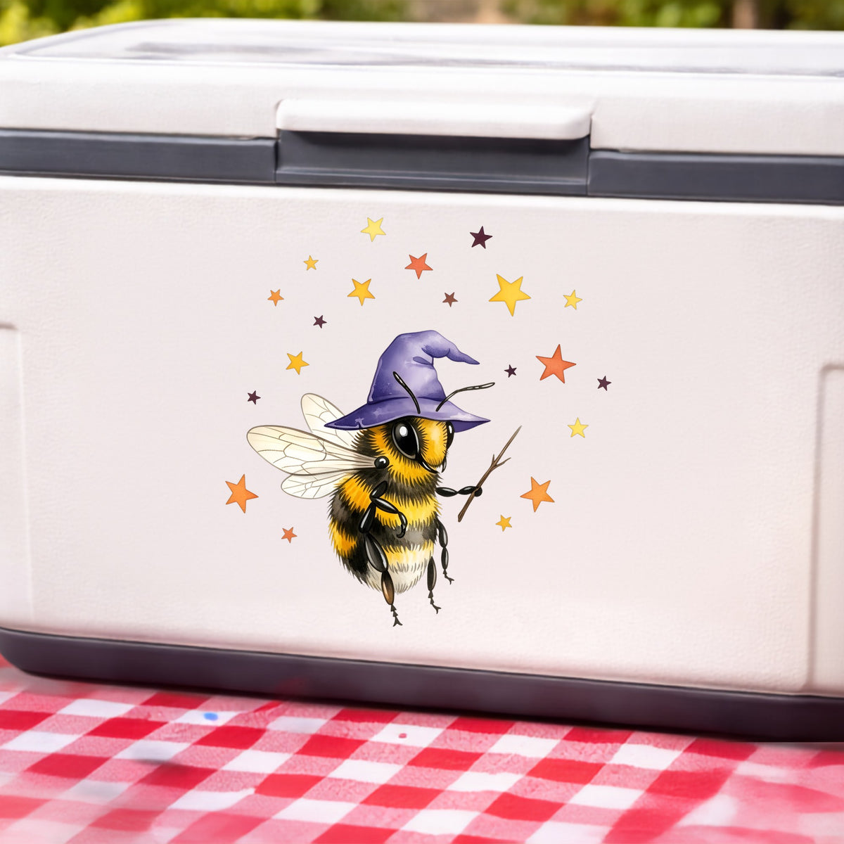 Bee Wizard With Stars UV DTF sticker applied to a white cooler on a red gingham cloth