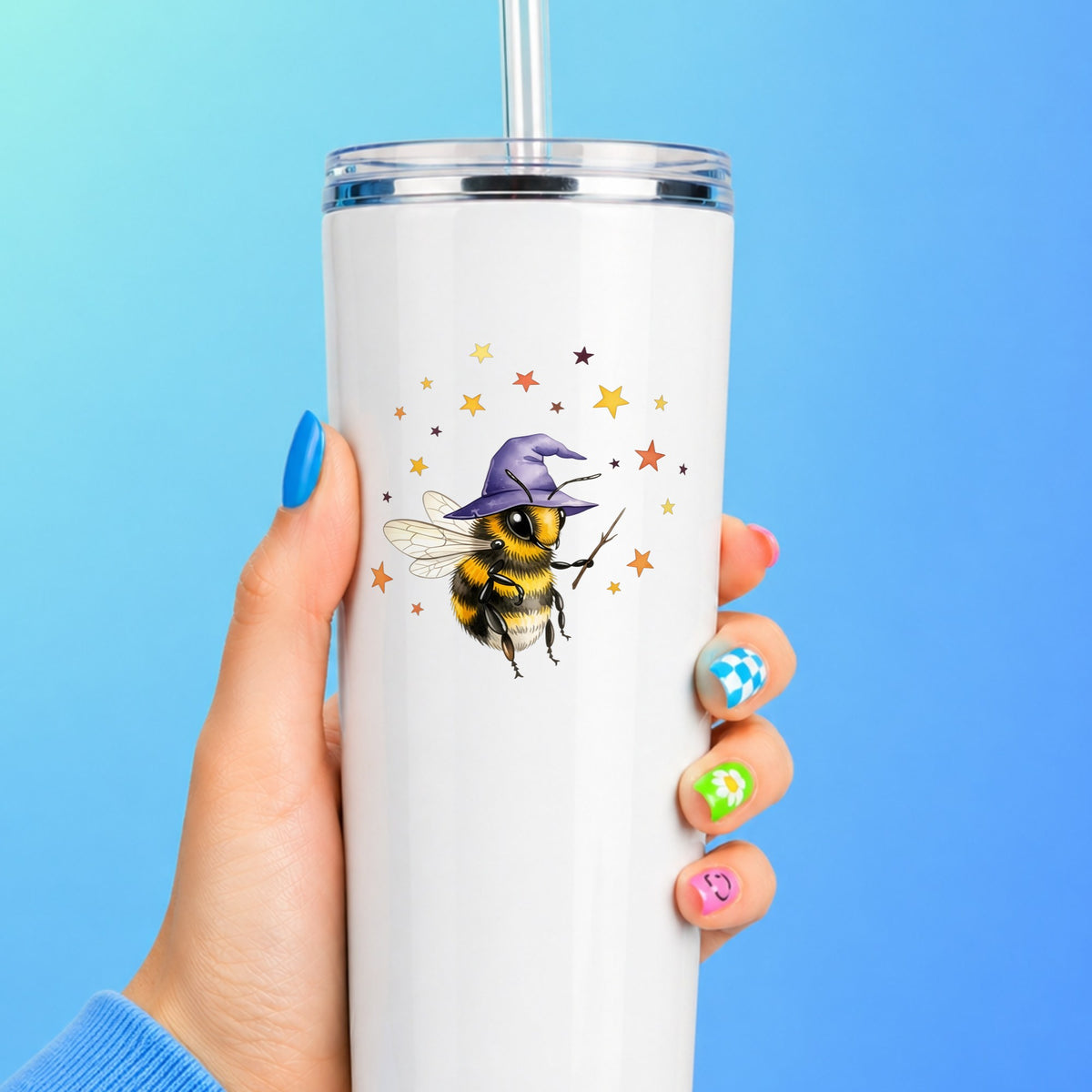 Bee Wizard With Stars UV DTF sticker applied to a white straw tumbler on a blue background