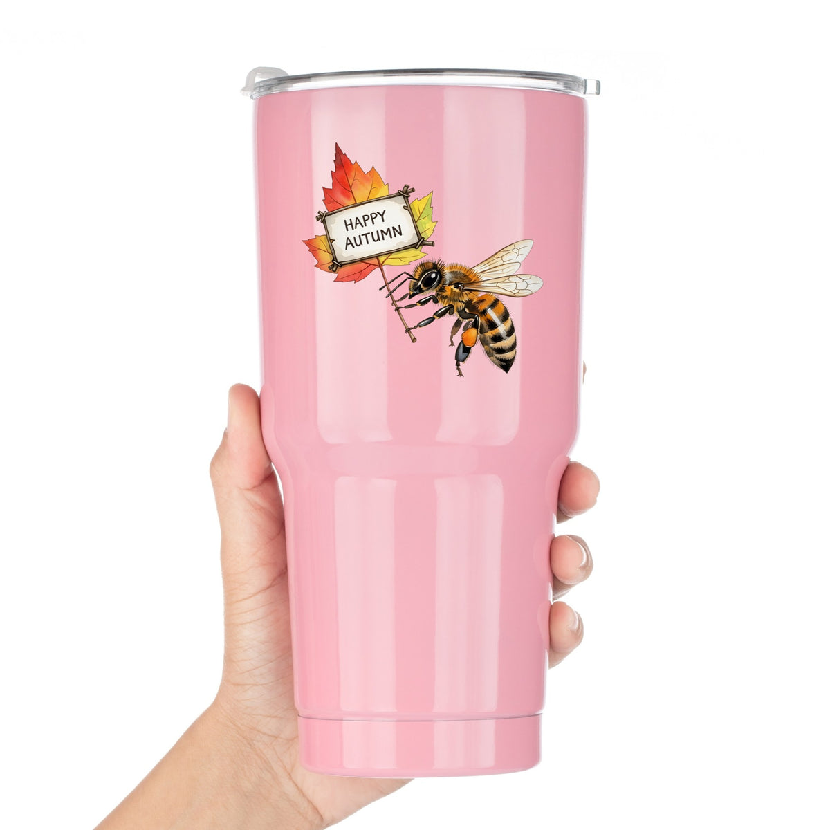 Honeybee Holding Happy Autumn Sign UV DTF sticker applied to a pink tumbler held against a white background