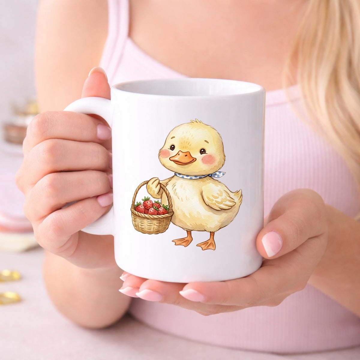 Duckling With Strawberry Basket UV DTF sticker applied to a white coffee mug held in both hands