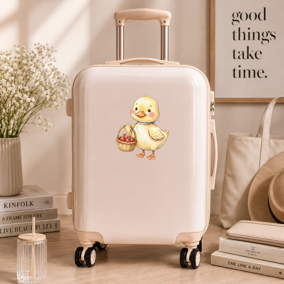 Duckling With Strawberry Basket UV DTF sticker applied to a cream carry-on suitcase