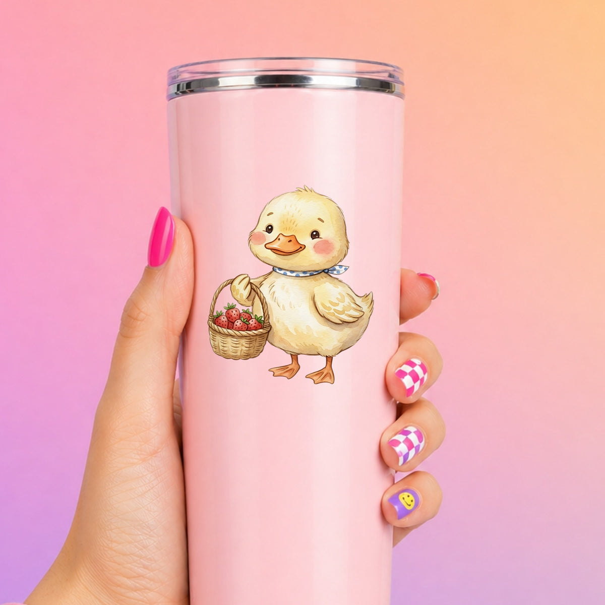 Duckling With Strawberry Basket UV DTF sticker applied to a tall pink tumbler on a pink and orange background