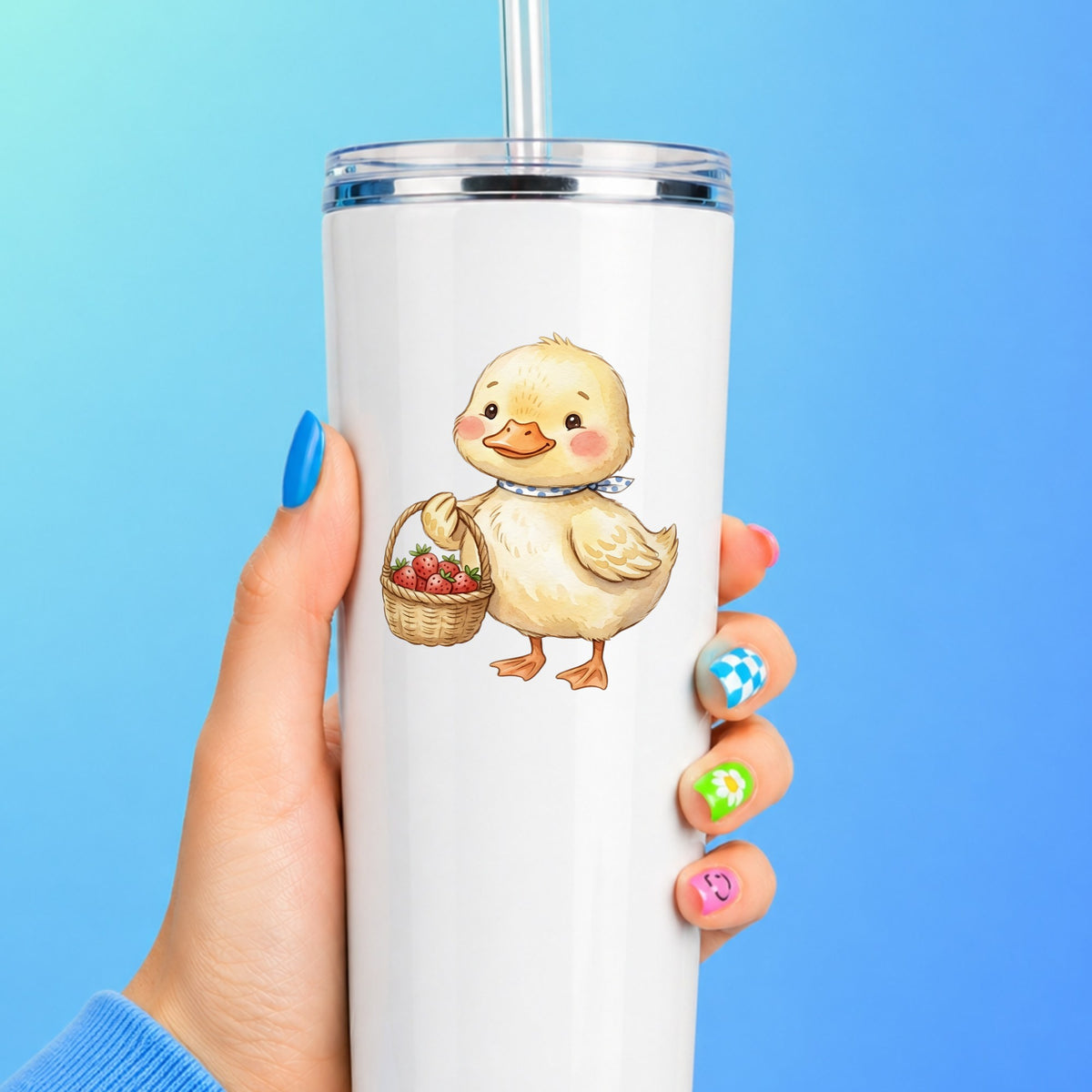 Duckling With Strawberry Basket UV DTF sticker applied to a white straw tumbler on a blue background