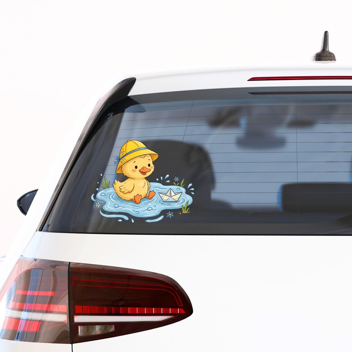 Duckling In Rain Hat In Puddle UV DTF sticker applied to the rear window of a white car