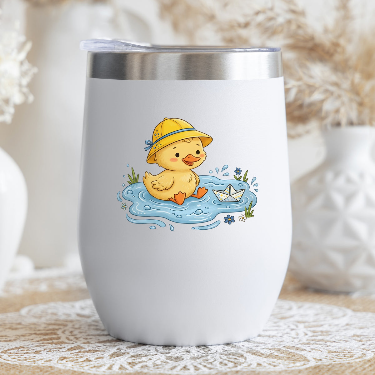 Duckling In Rain Hat In Puddle UV DTF sticker applied to a white stemless tumbler with a lid