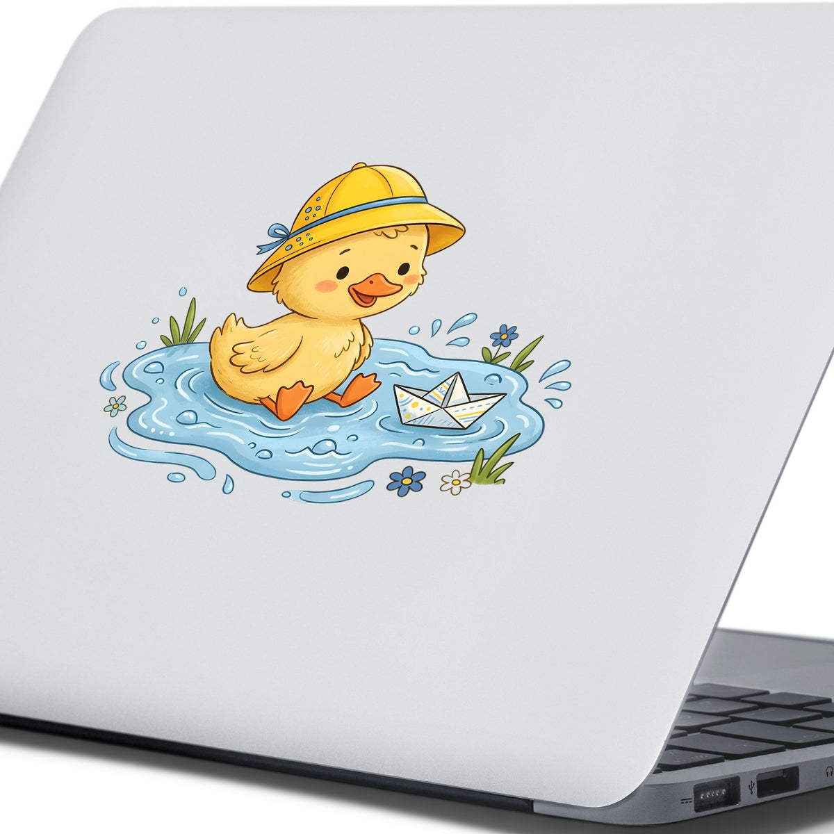 Duckling In Rain Hat In Puddle UV DTF sticker applied to the lid of a silver laptop