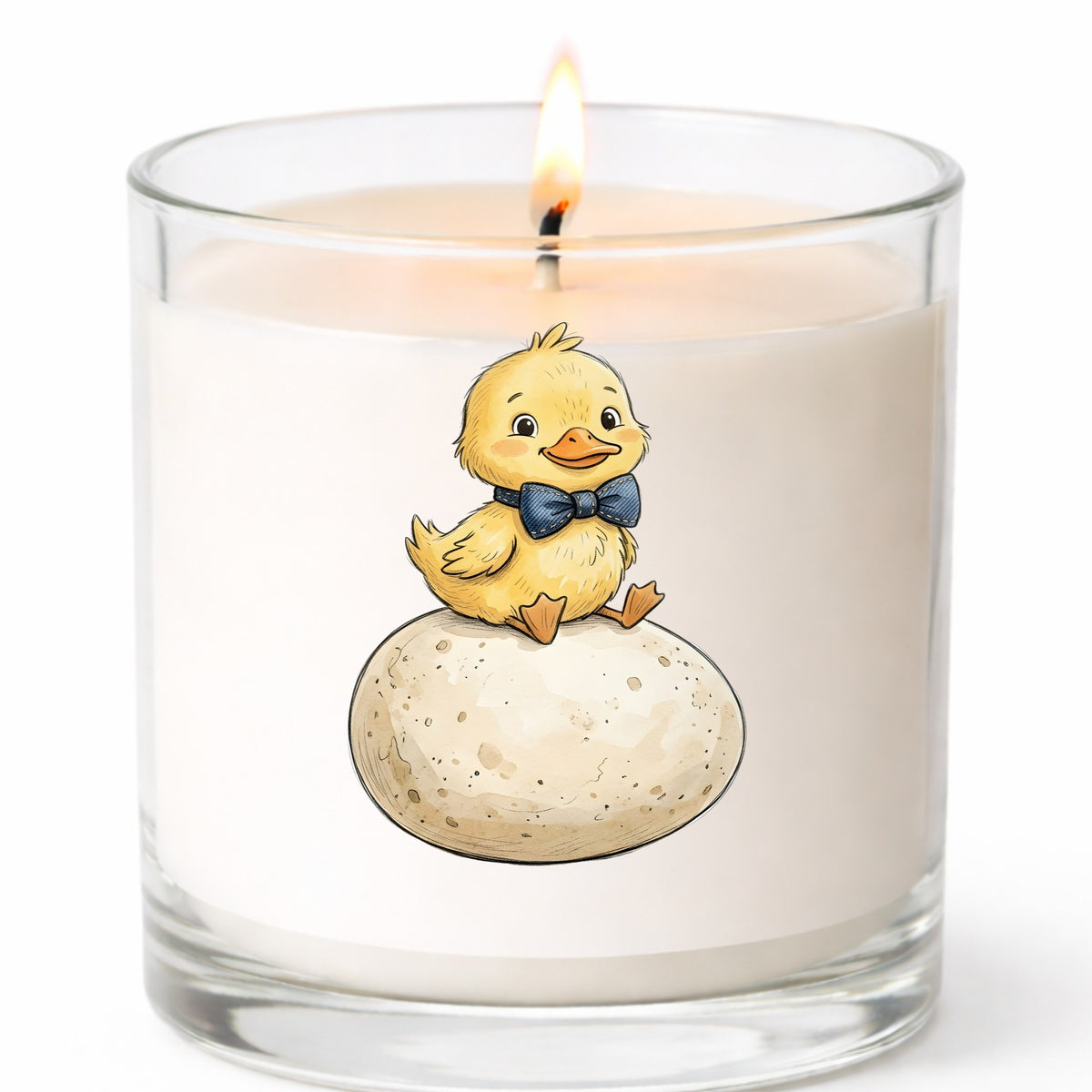 Duckling On Giant Egg UV DTF sticker applied to a white candle in a clear glass jar