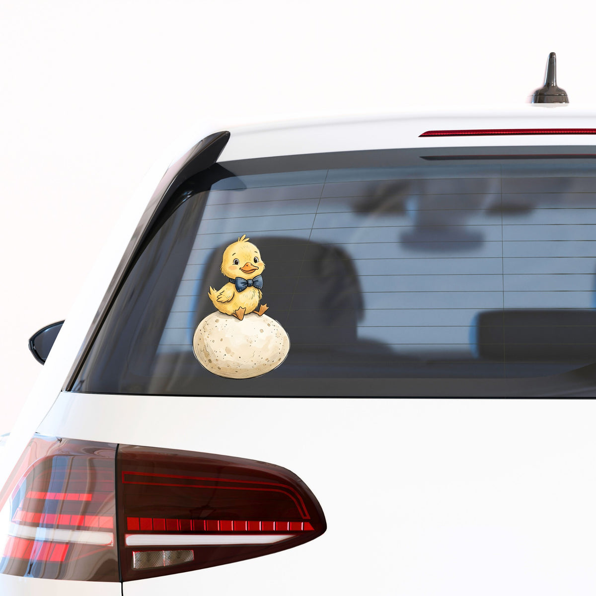 Duckling On Giant Egg UV DTF sticker applied to the rear window of a white car
