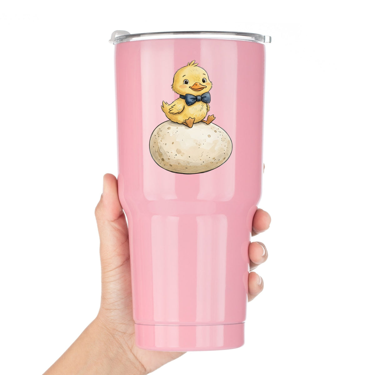 Duckling On Giant Egg UV DTF sticker applied to a pink tumbler held against a white background