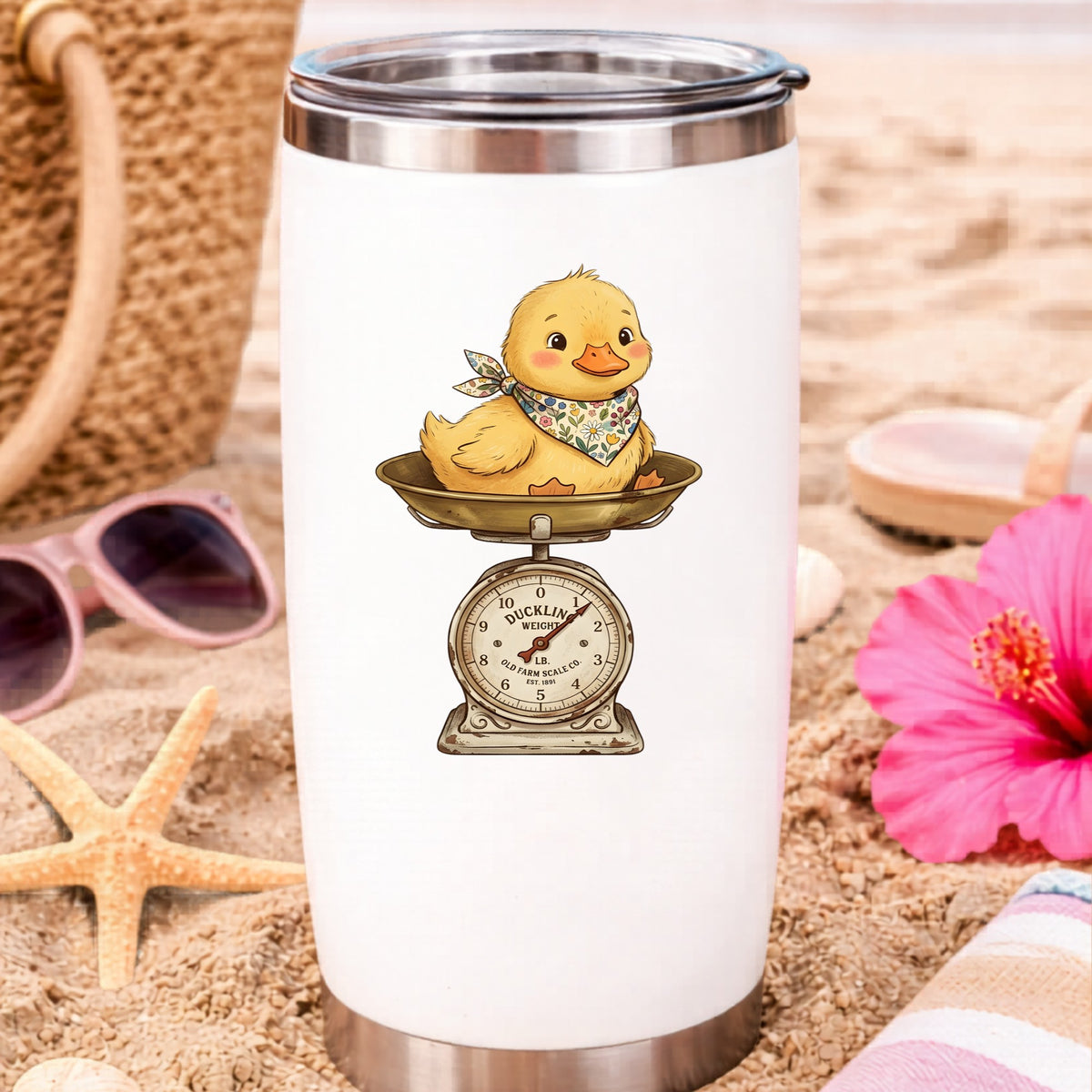Duckling On Vintage Farm Scale UV DTF sticker applied to a white travel tumbler on beach sand