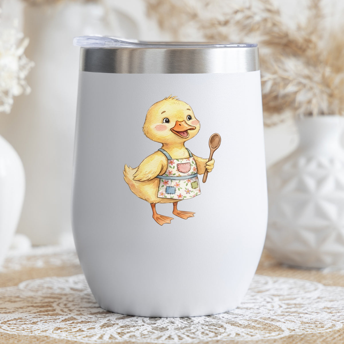 Duckling In Apron With Wooden Spoon UV DTF sticker applied to a white stemless tumbler with a lid