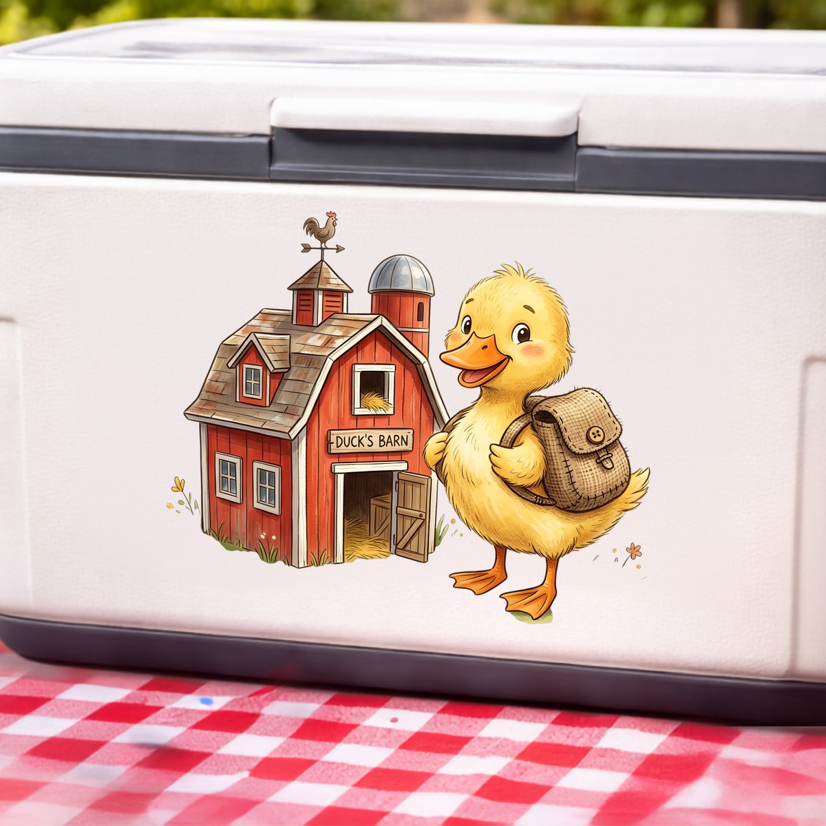 Duckling With Backpack And Red Barn UV DTF sticker applied to a white cooler on a red gingham cloth