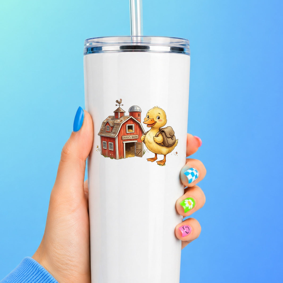 Duckling With Backpack And Red Barn UV DTF sticker applied to a white straw tumbler on a blue background