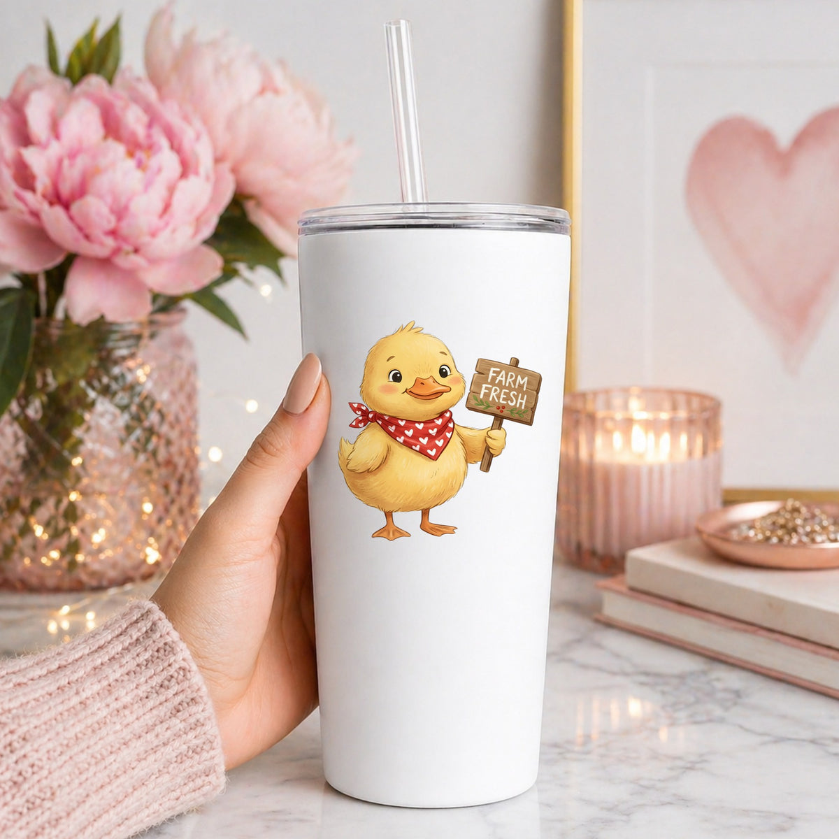 Duckling With Farm Fresh Sign UV DTF sticker applied to a white straw tumbler beside pink peonies