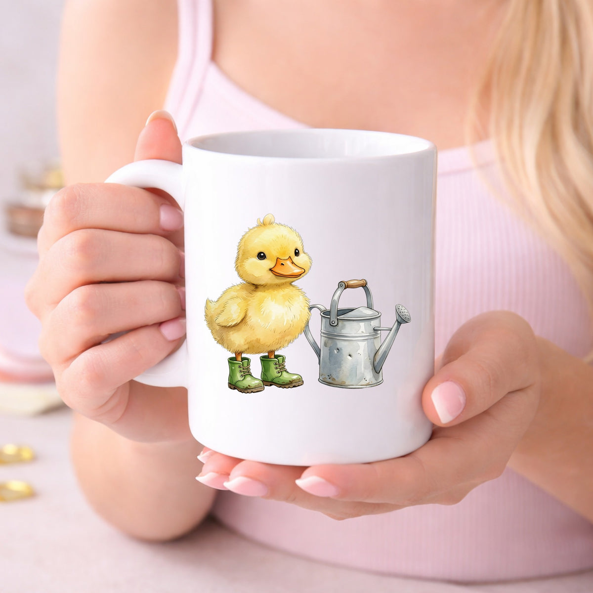 Duckling In Boots With Watering Can UV DTF sticker applied to a white coffee mug held in both hands