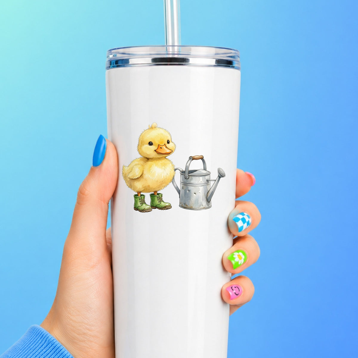 Duckling In Boots With Watering Can UV DTF sticker applied to a white straw tumbler on a blue background