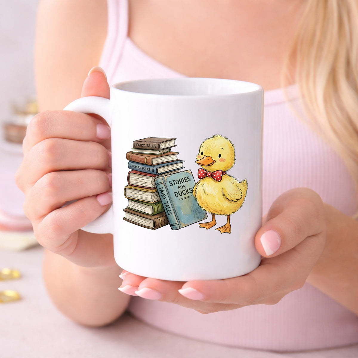 Duckling With Stack Of Storybooks UV DTF sticker applied to a white coffee mug held in both hands