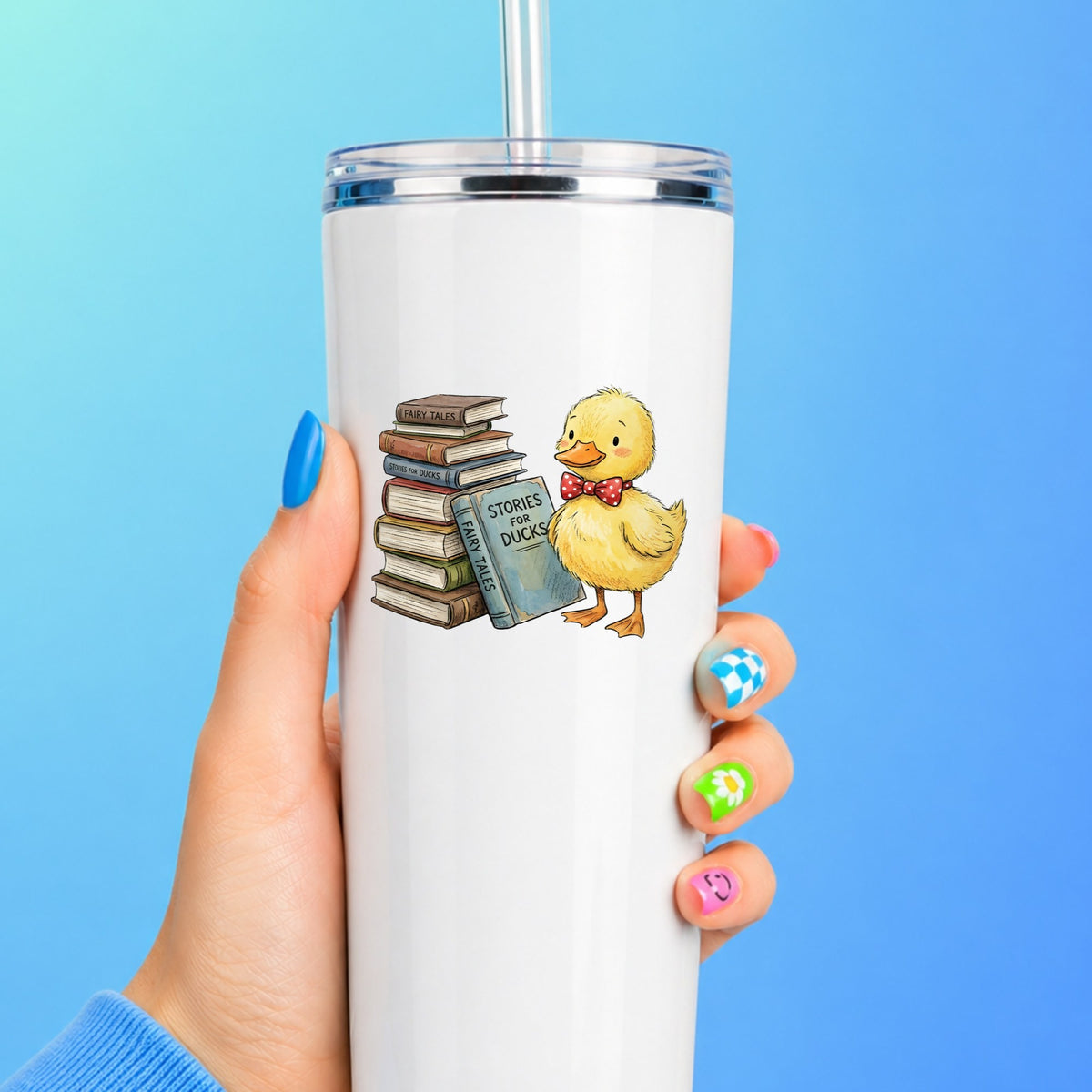 Duckling With Stack Of Storybooks UV DTF sticker applied to a white straw tumbler on a blue background