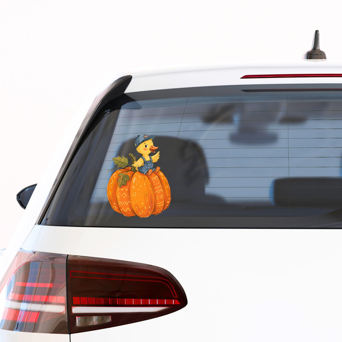 Duckling In Overalls On Pumpkin UV DTF sticker applied to the rear window of a white car