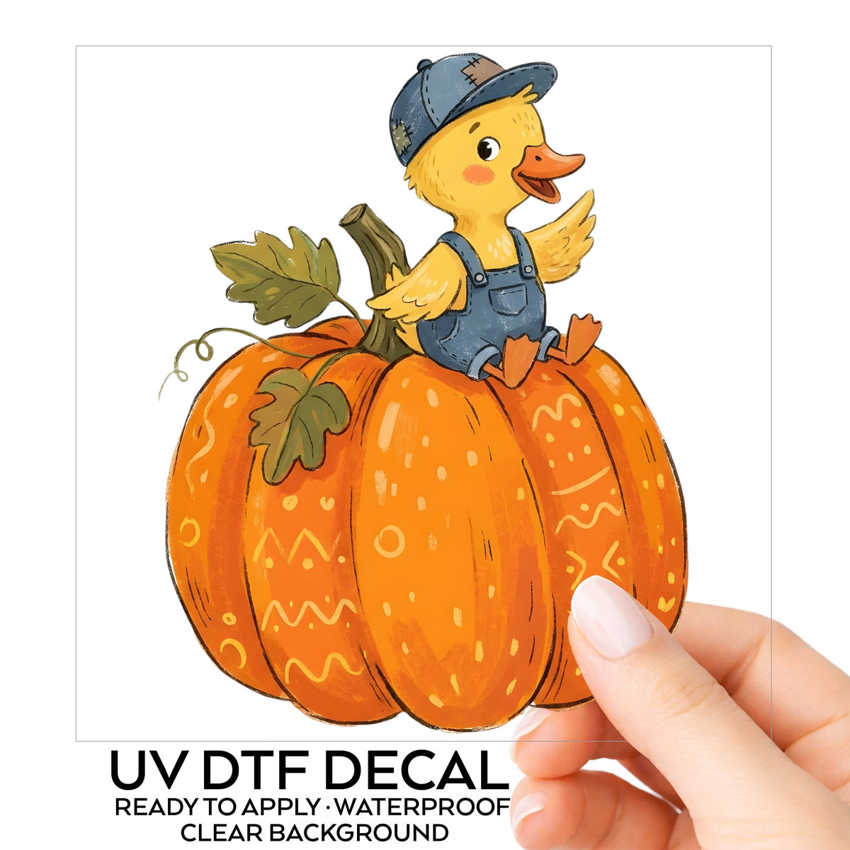 Duckling In Overalls On Pumpkin UV DTF sticker on its backing card, held in hand