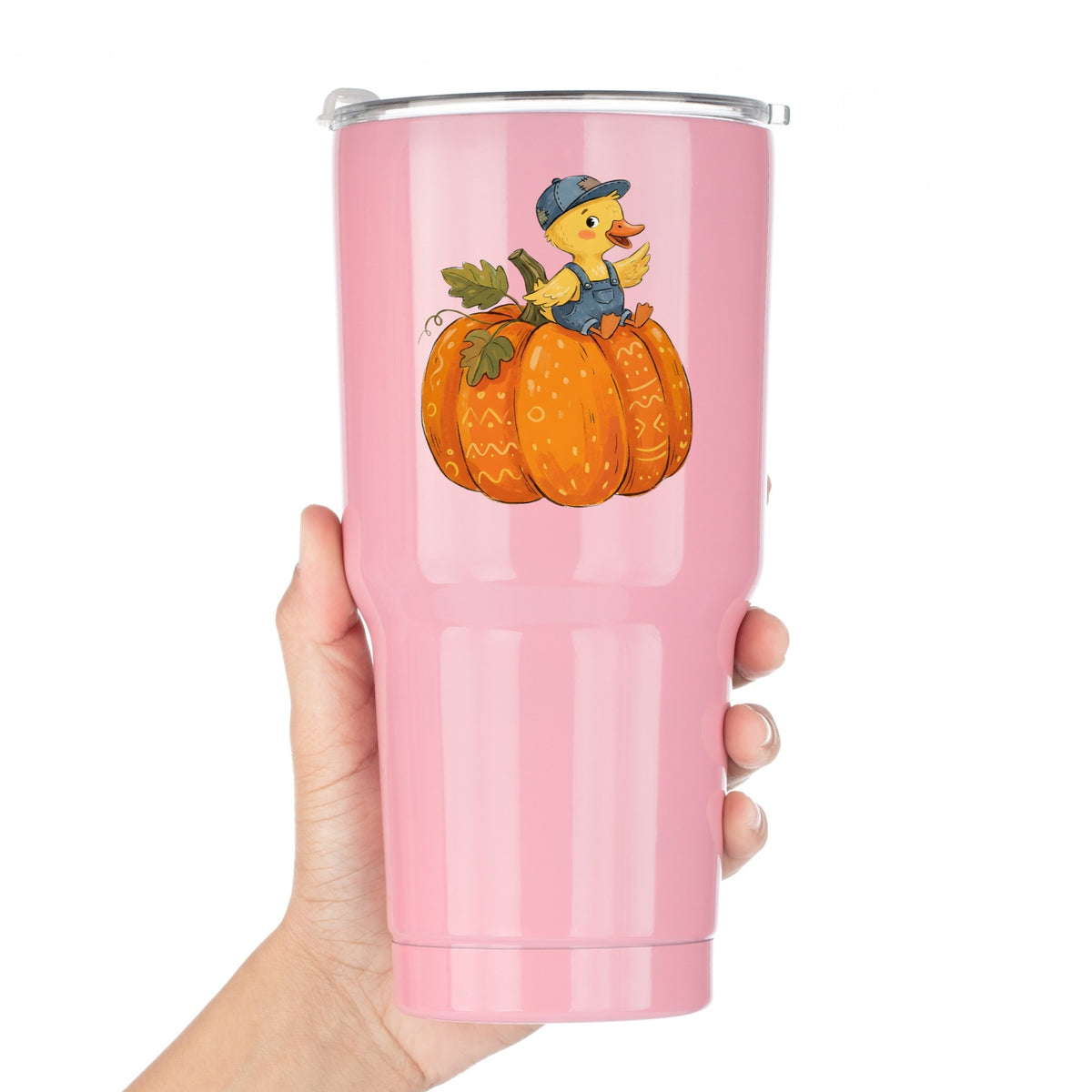 Duckling In Overalls On Pumpkin UV DTF sticker applied to a pink tumbler held against a white background
