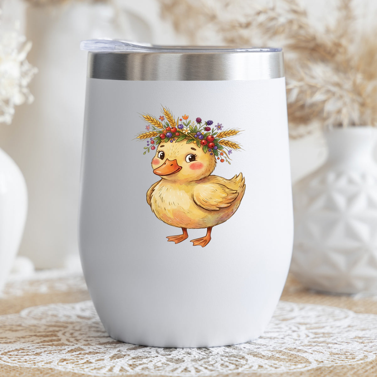 Duckling With Wheat And Berry Crown UV DTF sticker applied to a white stemless tumbler with a lid