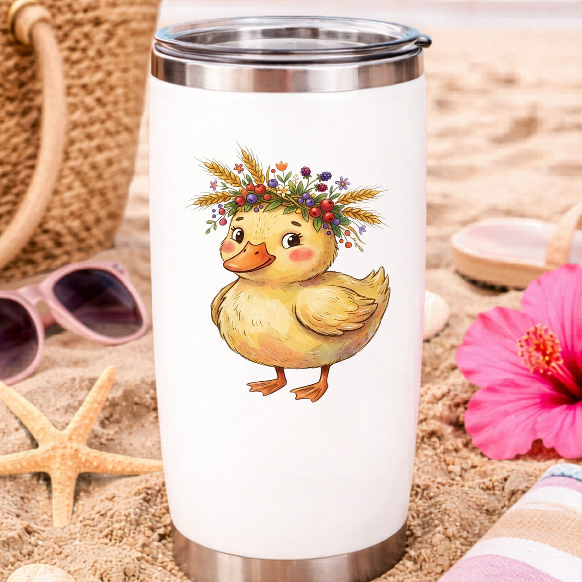 Duckling With Wheat And Berry Crown UV DTF sticker applied to a white travel tumbler on beach sand