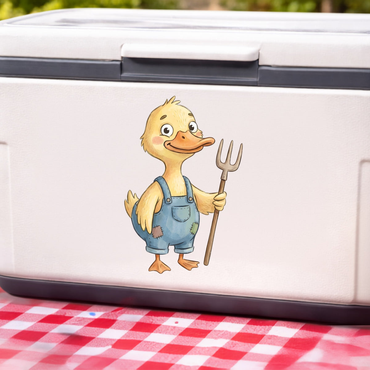 Duck In Overalls Holding Pitchfork UV DTF sticker applied to a white cooler on a red gingham cloth