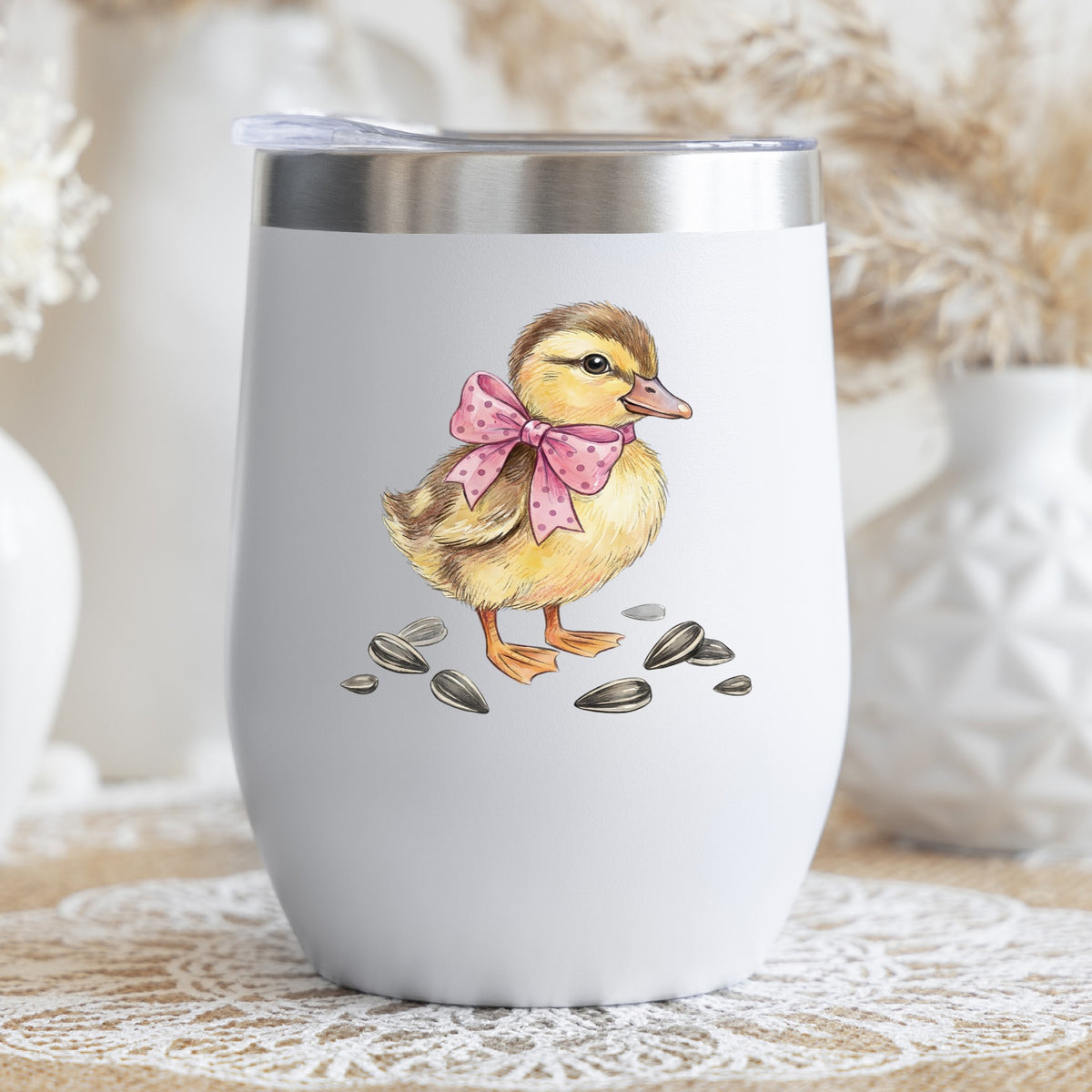 Brown Duckling With Pink Bow UV DTF sticker applied to a white stemless tumbler with a lid