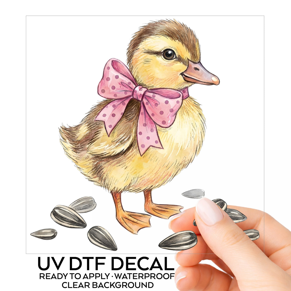 Brown Duckling With Pink Bow UV DTF sticker on its backing card, held in hand