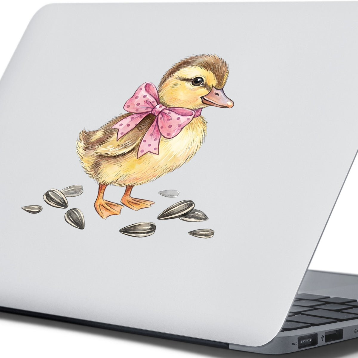 Brown Duckling With Pink Bow UV DTF sticker applied to the lid of a silver laptop