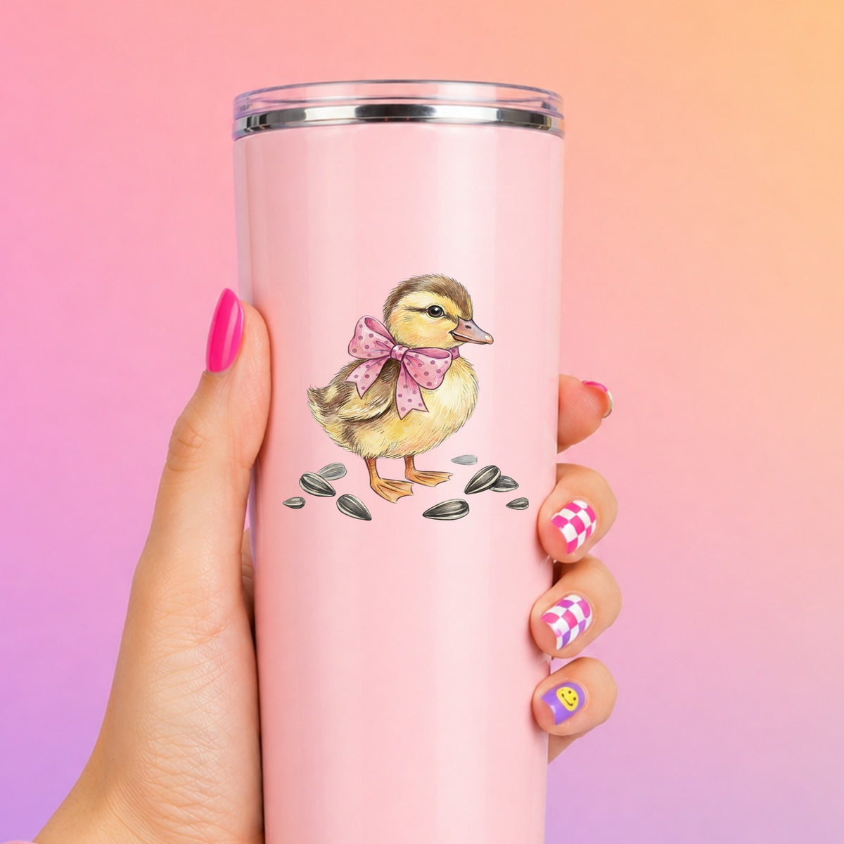 Brown Duckling With Pink Bow UV DTF sticker applied to a tall pink tumbler on a pink and orange background