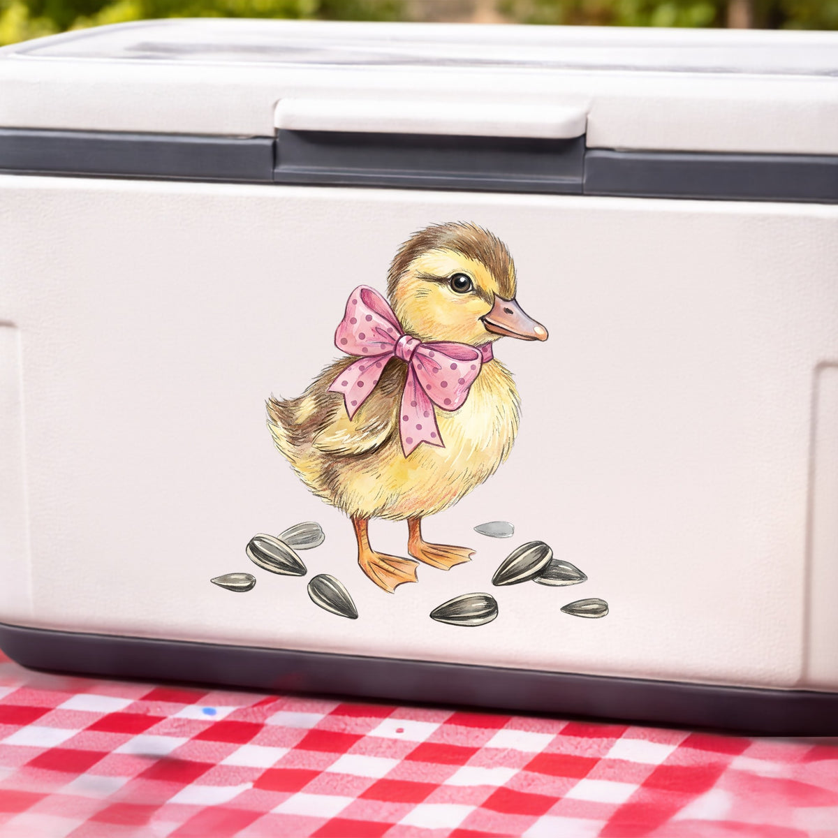 Brown Duckling With Pink Bow UV DTF sticker applied to a white cooler on a red gingham cloth