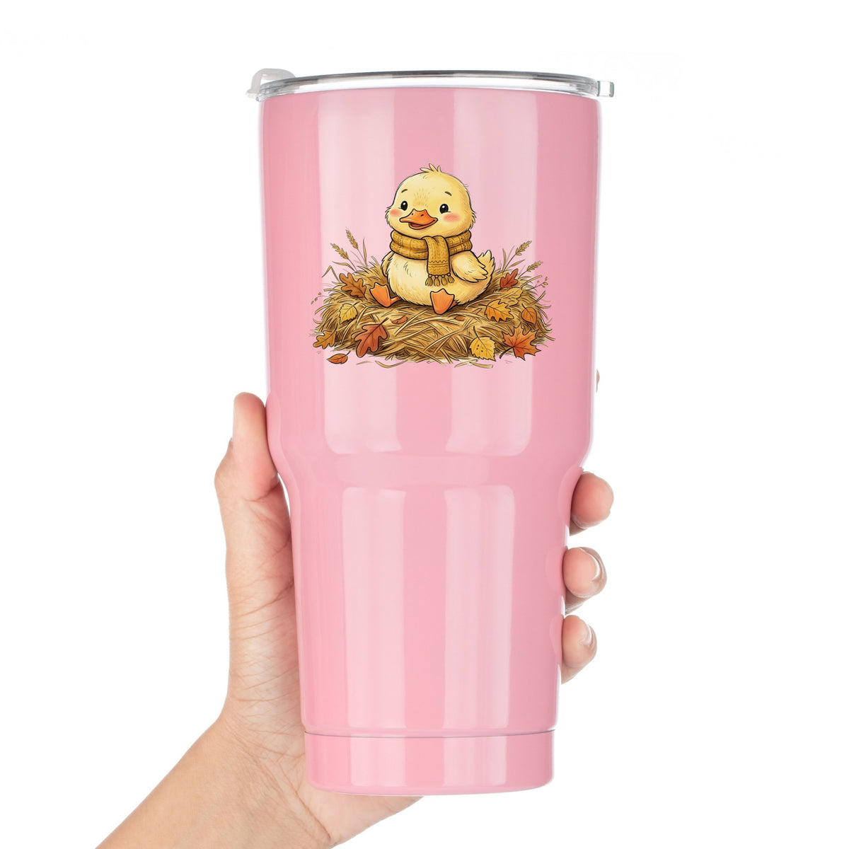 Duckling In Scarf On Hay With Autumn Leaves UV DTF sticker applied to a pink tumbler held against a white background