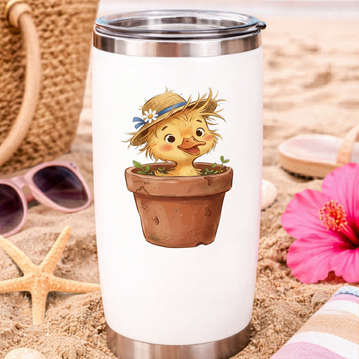 Fluffy Duckling In Flower Pot UV DTF sticker applied to a white travel tumbler on beach sand