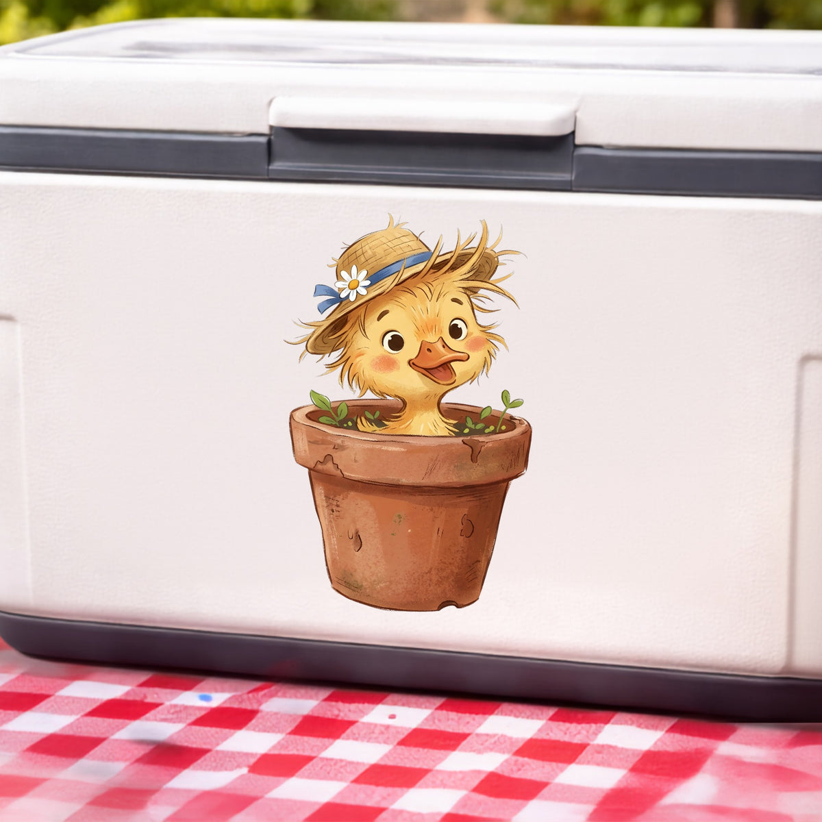 Fluffy Duckling In Flower Pot UV DTF sticker applied to a white cooler on a red gingham cloth