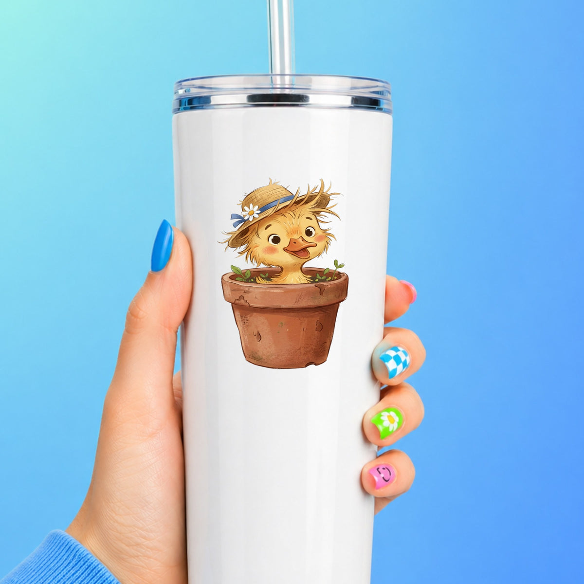 Fluffy Duckling In Flower Pot UV DTF sticker applied to a white straw tumbler on a blue background