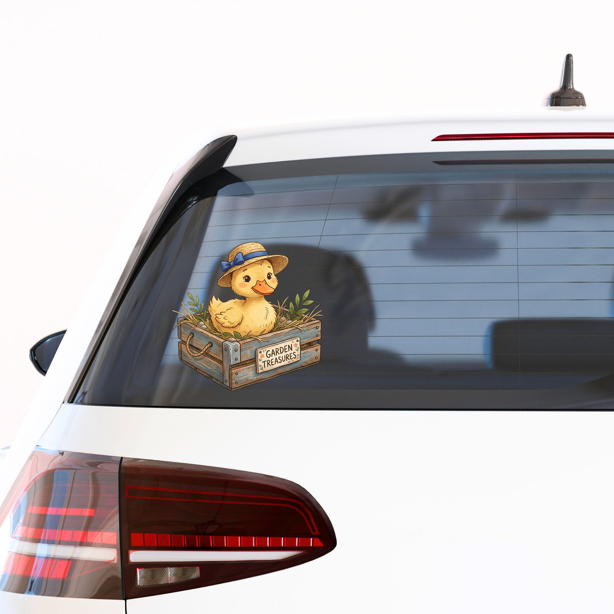 Duckling In Garden Treasures Crate UV DTF sticker applied to the rear window of a white car
