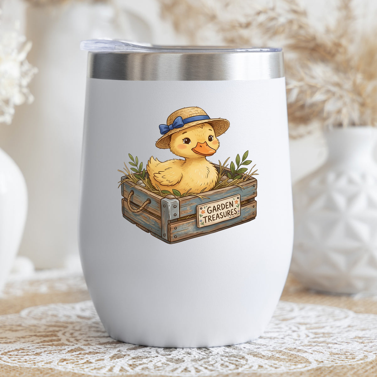 Duckling In Garden Treasures Crate UV DTF sticker applied to a white stemless tumbler with a lid